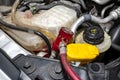 A red quick-release coupler is installed on the valve from the air conditioning system in the car to fill the R134a refrigerant., Royalty Free Stock Photo