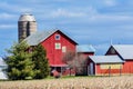 Red Quilt Barn with Evergreen Pine Trees and Silo Royalty Free Stock Photo