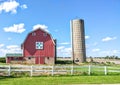 Red Quilt Barn with a Silo and a White Fence Royalty Free Stock Photo