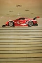 Red racecar at the top of the stairs Royalty Free Stock Photo