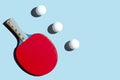 Red racket for table tennis with white balls on blue background. Ping pong sports equipment in minimal style. Flat lay, top view, Royalty Free Stock Photo