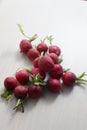 red radishes on wooden cutting board, and table