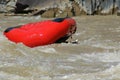 Red raft floating upside down in rapids Royalty Free Stock Photo