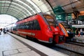 Red railway wagon train. A modern high speed train stands at Dresden railway station, Germany