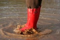 Red rain boots in puddle Royalty Free Stock Photo