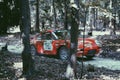 A red rally Porsche racing at GoodWood