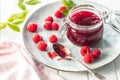 Red rasberries jam in jar and ripe raspberries Royalty Free Stock Photo