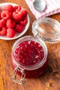 Red rasberries jam in jar and ripe raspberries Royalty Free Stock Photo