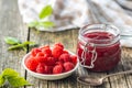 Red rasberries jam in jar and ripe raspberries Royalty Free Stock Photo