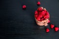 Red raspberries in a basket on black wooden background. Frame. Copy space. Top view. Royalty Free Stock Photo