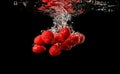 Red Raspberries Falls under Water with a Splash, isolated on black background Royalty Free Stock Photo