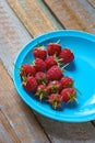 Red raspberry in blue green dish on old vintage wooden table. Royalty Free Stock Photo