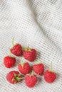 Red raspberry in front of white fabric on old vintage wooden tabl Royalty Free Stock Photo