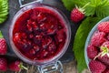 Red raspberry jam and fresh raspberry on a wooden table. Rustic style, closeup, top view Royalty Free Stock Photo