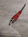 Red RCA cable on textured surface Royalty Free Stock Photo