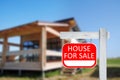 Red real estate sign with inscription HOUSE FOR SALE on sunny day, space for text