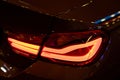 Red Rear light on a modern car with reflection. The Closeup Back Red Tail light car. Royalty Free Stock Photo