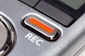 Red REC recording button on a modern pocket audio voice recorder, switch object macro extreme closeup Secretly recording