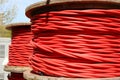 red reel of high voltage electrical cable used for transporting electricity from a power plant