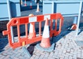 Red reflective traffic cones and safety barrier installed during roadworks to separate safe walking area from traffic Royalty Free Stock Photo