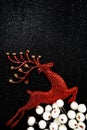 Red Reindeer and white berry Christmas decoration on black glitter background Royalty Free Stock Photo