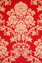 Red renaissance wallpaper with golden floral texture