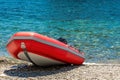 Red rescue inflatable boat, closeup. Empty marine rescue boat. Inflatable boat on the beach it is red in colour with a grey floor