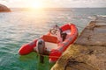 Red rescue inflatable boat moored to the sea pier, closeup. Empty marine rescue boat Royalty Free Stock Photo