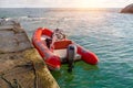 Red rescue inflatable boat moored to the sea pier, closeup. Empty marine rescue boat Royalty Free Stock Photo