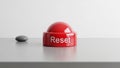 Red Reset Button on White Surface With Stone Royalty Free Stock Photo