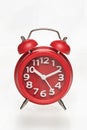 Red retro alarm clock with digital dial and hour hands on white background Royalty Free Stock Photo
