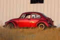 Red retro car beetle parking at roadside Royalty Free Stock Photo