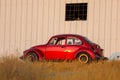 Red retro car beetle parking at roadside Royalty Free Stock Photo