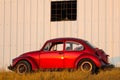 Red retro car beetle parking at roadside Royalty Free Stock Photo