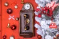 Red retro phone box with vintage wooden telephone is decorated with Christmas tree, balls. Royalty Free Stock Photo