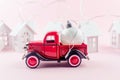 Red retro Pickup with Christmas ball on pastel pink