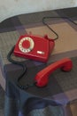 Red retro rotary telephone on table, vertical image Royalty Free Stock Photo