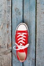 Red retro sneakers on a blue wooden background Royalty Free Stock Photo