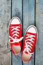 Red retro sneakers on a blue wooden background Royalty Free Stock Photo