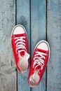 Red retro sneakers on a blue wooden background Royalty Free Stock Photo