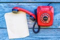 Red retro telephone and a sheet of paper for records Royalty Free Stock Photo