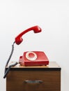 Red retro telephone on wooden nightstand Royalty Free Stock Photo