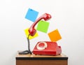 Red retro telephone on wooden nightstand Royalty Free Stock Photo