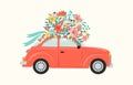 Red retro toy car delivering bouquet of flowers box on pink background. February 14 card, Valentines day. Flower Royalty Free Stock Photo