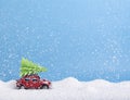 Red retro toy car hasten to delivery Christmas pine tree Royalty Free Stock Photo