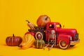 Red retro truck with pumpkins and skeleton on a yellow background. Halloween and Thanksgiving concept