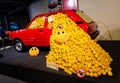 Red Retro vintage car filled with yellow colour balls Royalty Free Stock Photo