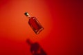 Red Reverie: Suspended Whisky Bottle.