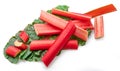 Red rhubarb stems\' cuts over rhubarb leaves isolated on white background Royalty Free Stock Photo