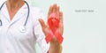 Red ribbon for AIDS awareness in doctor`s hand, HIV illness campaign. Copy space Royalty Free Stock Photo